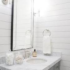The carrara marble countertop, complementary floor tile and chrome fixtures all exude coolness, but using super white on the shiplap walls keeps the space from feeling stark or icy. Gray Bath Vanity With White Shiplap Walls White Shiplap Wall Vanity Single Sink Vanity