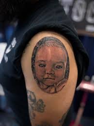 Who are recommended tattoo artists for portraits in black and white?