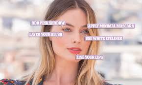 She carried a dangling hard case purse about the size of a small camera that as silver and pink. How To Look Like Margot Robbie Actress S Makeup Artist Shares Secrets Behind The Star S Look Daily Mail Online