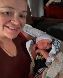 Grandma Amy beams with her children and grandchildren