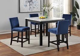 For the ultimate minimalist look, pair a white dining table with either clear acrylic or white dining chairs, keeping the room simple and neutral in both style and hue. White Marble Dining Table W 4 Blue Velvet Chairs Top Home Furniture