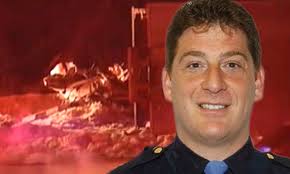 Veteran police officer dies after parked patrol car is crushed by 2 lorries 