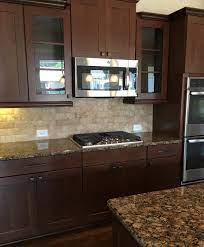 Gourmet Kitchen With Easy To Clean Cooktop Beautiful Mexican Traverti Kitchen Cabinets And Backsplash Cherry Cabinets Kitchen Backsplash Kitchen Dark Cabinets