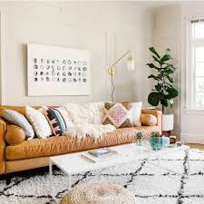 Textured Rug And Throw Cushions Contrast Beautifully With Simple Tan Leather Couch And Neutral Walls Living Room Designs Boho Living Room Living Room Decor