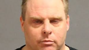 T cop held after armed standoff at N.H. hotel