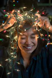 Check spelling or type a new query. Mixed Race Woman Holding String Lights On Head Near Christmas Tree Stockphoto