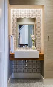 Though counterintuitive, larger format tiles for walls and floors work well in powder rooms. Contemporary Powder Room With Ronbow Cb3012 1 200212 1 Wh Rectangle Ceramic Contemporary Powder Room Powder Room Design Modern Powder Rooms