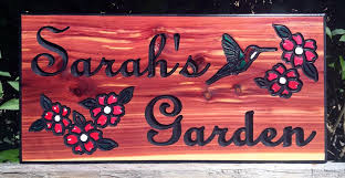 It is just three wood planks glued together and secured using another small plank and some finishing nails. Beautiful Personalized Wood Sign With Hand Painted Flowers
