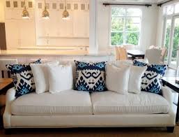 Even decorative throw pillows are susceptible; White Sofa With White And Blue Throw Pillows White Sofa Pillows Sofa Decor Contemporary Sofa