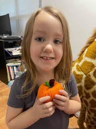 Girls decorate pumpkins with craft kits