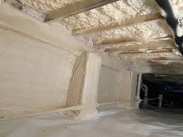 Crawl space with closed-cell spray foam insulation preventing ground moisture intrusion.