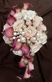 Just the special touch your flowers needed! Beautiful Fushia Calla Lilies With Pale Pink Roses Accented With Some Jewels Bridal Bouquet Wedding Bouquets Beautiful Bouquet