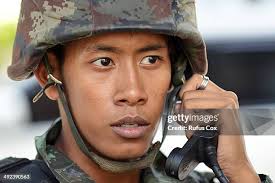 A Thai army officer briefs soldiers standing guard outside the... News  Photo