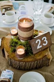 Wood Slice Centerpiece With Moss And Candles And Table Numbers On A Wood Piece Simple Wedding Centerpieces Rustic Wedding Table Table Numbers Wedding Rustic