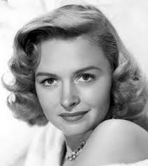 Bridget Regan in a marketing photograph for her role as Dottie Underwood in  the "Agent Carter" TV series. She looks ready to appear