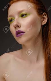 If you've glanced around anywhere lately, then you're well aware that nothing is more in style right now than gorgeous red tresses. Close Portrait Of A Red Haired Girl With Freckles And Blue Eyes With Purple Lipstick And Green Arrows Stock Photo Picture And Royalty Free Image Image 140948708