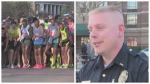 Officer helps runner cross finish line
