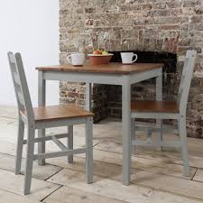 Featuring a sleek black finish, this seamless neutral dining set will prove to be a wonderful addition to your kitchen, game room, or living room. Annika Bistro Set With Two Chairs In Silk Grey Noa Nani