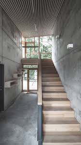 Inside Raw Concrete Walls And Floors Are Paired With Pine Plywood Panelling And Bamboo Stairs While Concrete Walls Interior Concrete Interiors Diy Staircase