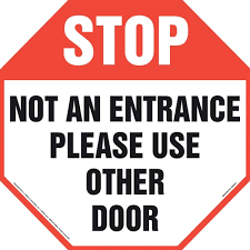 I would read the sign as please use the other door. Stop Not An Entrance Please Use Other Door Sign