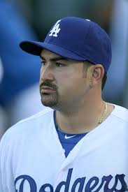 First baseman Adrian Gonzalez #23 of the Los Angeles Dodgers waits in the dugout before the game with the Miami Marlins on August ... - Adrian%2BGonzalez%2BMiami%2BMarlins%2Bv%2BLos%2BAngeles%2BHB9t1cQL9S4l