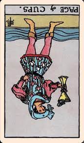 The page of cups is dressed in a fancy blue tunic embellished with floral prints. The Card Of The Day Page Of Cups Reversed Elliot Oracle Tarot Card Readings