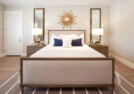Shiny Sunburst Mirror In A Beige Bedroom Decoist Bedroom Wall Decor Above Bed Bedroom Night Stands Mirror Over Bed