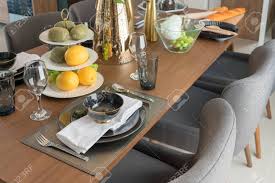 What is the best durable finish for a dining room table? Modern Table Set On Wooden Dining Table In Modern Dining Room Interior Design Concept Stock Photo Picture And Royalty Free Image Image 107313053