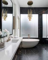 the litze bath collection in brilliance luxe gold and a bold chandelier accent luxu modern luxury bathroom luxury bathroom design modern white marble bathrooms