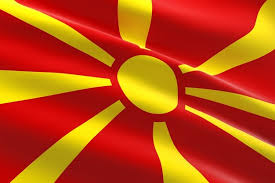 National flag consisting of a red field with a golden central disk and golden rays extending to the flag edges. Die Flagge In Skopje Mazedonien Balkan Premium Foto
