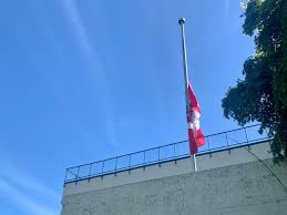 A flag that is at half mast has been brought down to a point halfway down the pole as an…. Vptrziww1qc0zm