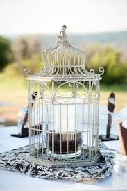 Birdcages serve as graceful table centrepieces. 20 Lovely Repurposed Bird Cages