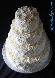 You can cluster them together as a topper, or place them on each tier so they trail down the side. Ivory Buttercream Roses Wedding Cake With Lovebirds Cake Topper