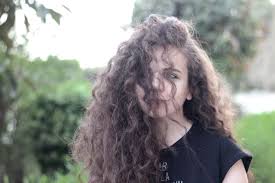 Rear view of a young woman. Back To Old School Natural Curly Hair Fashion Paradoxes