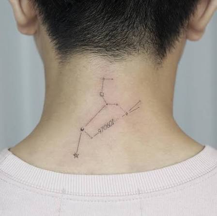 Leo constellation and date tattooed on the back of the