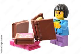 Foto de Stock Lego minifigure with a book isolated on white. Editorial  illustrative image of reading and learning. | Adobe Stock