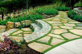 A large stone is used to span a constructed stream in this rock garden landscape. 50 Very Creative And Inspiring Garden Stone Pathway Ideas