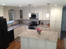 This is a gorgeous transitional style white kitchen which has dark walnut floors, creating a good contrast of colors between the floors and the white surfaces. California Kitchen With White Shaker Cabinets Island