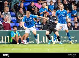 Stockport, UK. 30th July, 2022. Will Collar (14) of Stockport County  challenged by Robbie Gotts (15) of Barrow AFC during the Sky Bet League 2  match between Stockport County and Barrow at