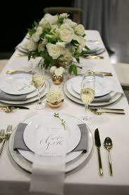 Throw a fancy dinner party put a bow on it instead of rolling up your napkin, wrap ribbon around the middle and cinch into a bow. Elegant White Table Setting By Stem Floral Design Dinner Table Decor Dinner Table Setting Dinner Party Table