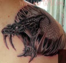 Scary snake tattoose on the leg. Snake Tattoo History Designs And Meanings Tatring