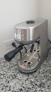 Close and lock the top of the machine and plug in. The Bambino Espresso Machine Breville