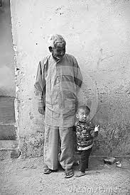 Black And White Street Photography India A Black And White Image Of An Old Man And Child Stand On The Street Corner Of A Rural Indian Village With The Grandpa White Image India Culture Indian Village