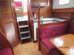 Interior finishing with solid oiled teak wood and the bulkheads are painted with classic beige color. 1976 Fisher 37 Ocean Yacht Sales