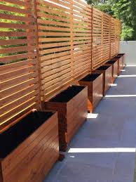 One of the most popular privacy fence screen ideas is to use decorative panels. Timber Privacy Divider Screen Trellis With Horizontal Slats Privacy Fence Designs Backyard Privacy Backyard
