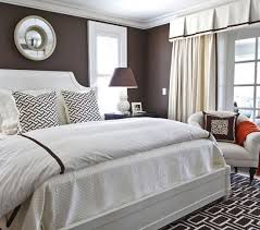 Primary bedroom featuring a stunning white and brown tray ceiling, along with brown walls and hardwood floors. Bedroom Paint Ideas Brown Bedroom Contemporary Bedroom Home