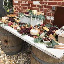 Wedding Grazing Table On A Timber Door And Wine Barrels Yum Cheese Table Wedding Wedding Buffet Food Buffet Wedding Reception