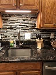 If you use black granite with light cabinetry and a white backsplash you are going to brighten up the room. Black Brown Granite Oak Cabinets Grey Backsplash Stone Backsplash Brown Granite Countertops Brown Kitchen Cabinets Granite Countertops Kitchen