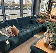 How to decorate a living room with green sofas and a TV?