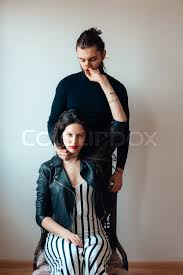 This gives the image of a man spreading his legs while standing. Girl Sitting On A Chair Guy Standing Stock Image Colourbox